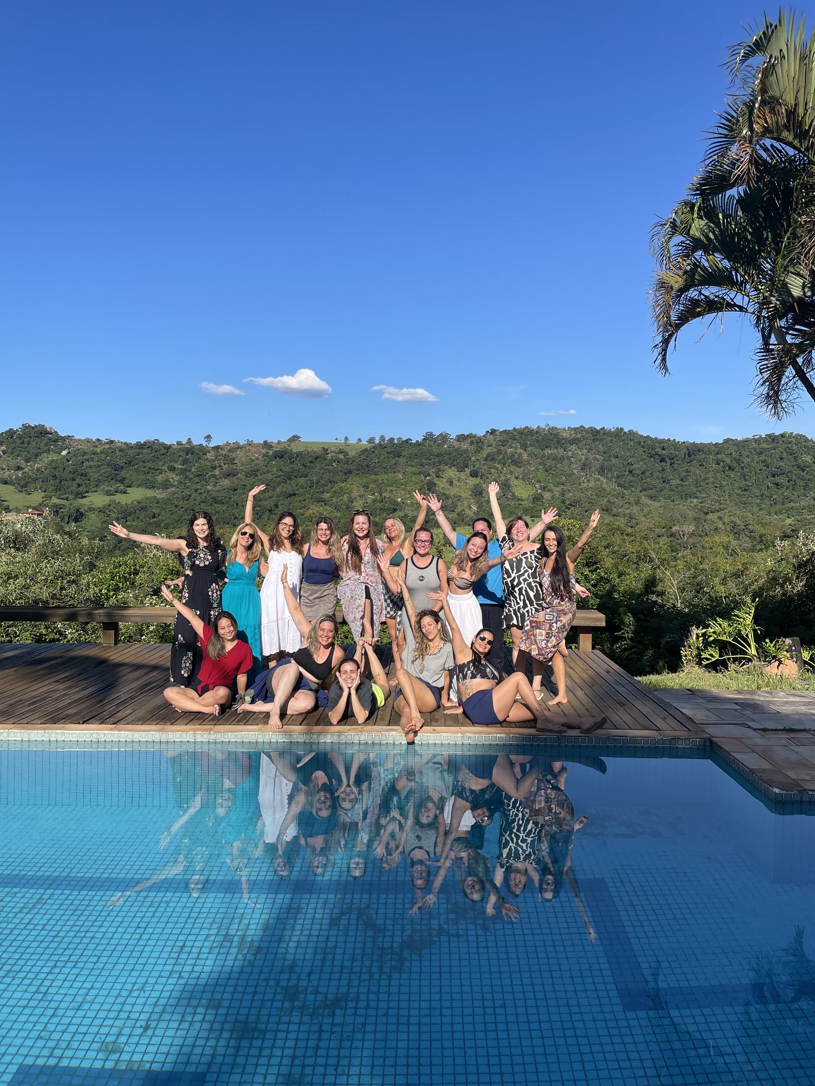 Participantes do retiro terapêutico LoveDetox reunidos na piscina cercada por natureza